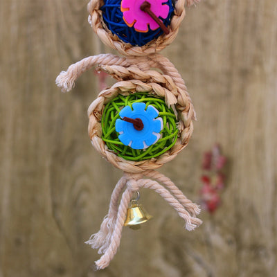 Colorful bird toy with three woven vine balls, internal pink, blue, and green string, felt flowers, and a bell. - Image 7