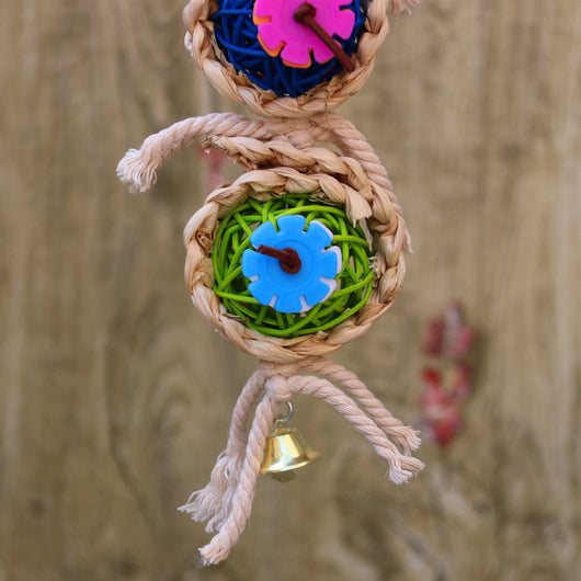 Colorful bird toy with three woven vine balls, internal pink, blue, and green string, felt flowers, and a bell. - Image 7