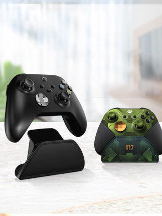 Black AOLION universal gamepad stand made of ABS plastic, designed to hold a game controller upright. - Image 4
