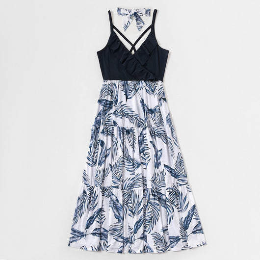 Young boy wearing a white short-sleeve t-shirt with blue tropical leaf print and a black chest pocket. - Image 19