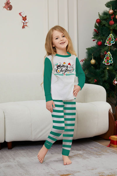 Family of four wearing matching green and white striped Christmas pajamas with "Merry Christmas" graphic. - Image 9