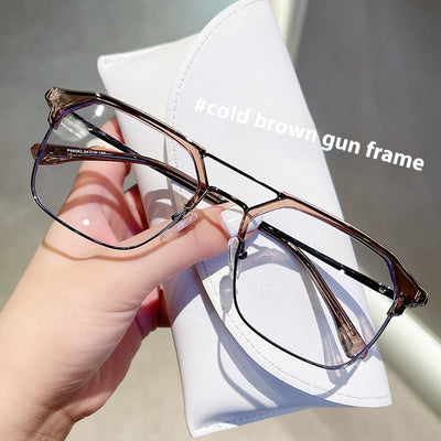 Anti-blue light glasses with a sand black and silver double beam frame, held against a white case. - Image 6