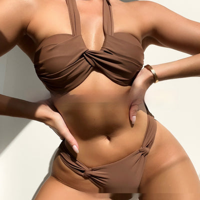 White solid color bikini swimwear with a halter top and knotted details on the top and bottom, modeled by a woman. - Image 2