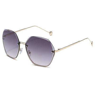 Elegant fashion sunglasses with gold metal frames and pink gradient lenses, held against a white case. - Image 3