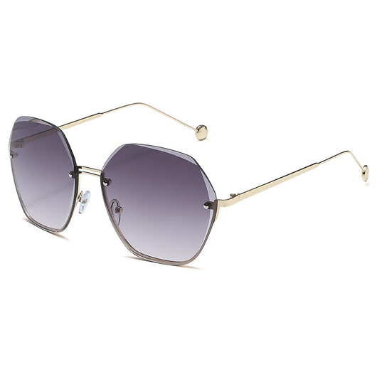 Elegant fashion sunglasses with gold metal frames and pink gradient lenses, held against a white case. - Image 3
