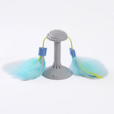 Gray suction cup cat toy with a textured top and two blue and yellow feathered wands attached by green cords. - Image 5