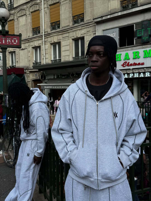 Light gray hooded tracksuit with dark gray contrast stitching, featuring a full-zip hoodie and matching loose sweatpants. - Image 12