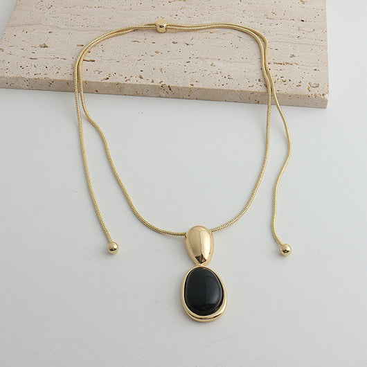 Pair of gold-toned irregular earrings with black onyx-like inserts, featuring a modern, abstract design. - Image 6