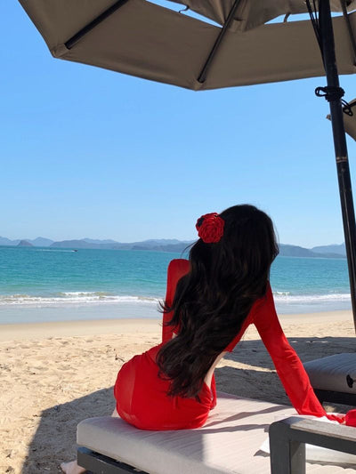 Red four-piece bikini set with sheer long-sleeve tie-front top and matching tie-front skirt on a beach. - Image 19
