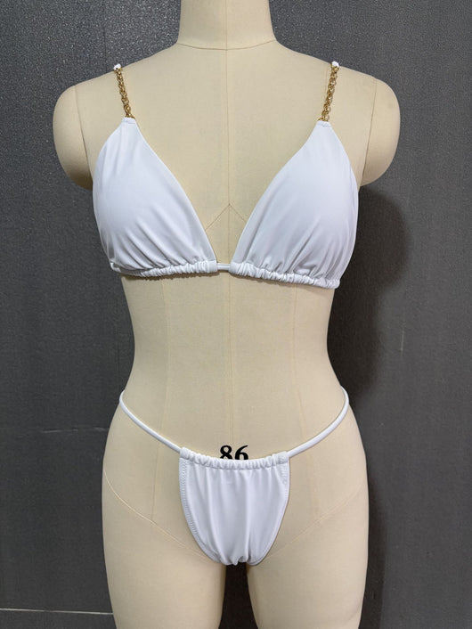 White three-point bikini with gold chain straps on a mannequin, featuring a triangle top and thong bottom. - Image 9