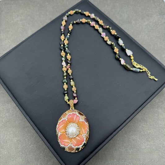 Gold-toned dangle earrings with oval drops, featuring a carved pink flower, clear rhinestones, and multi-colored tourmaline. - Image 2