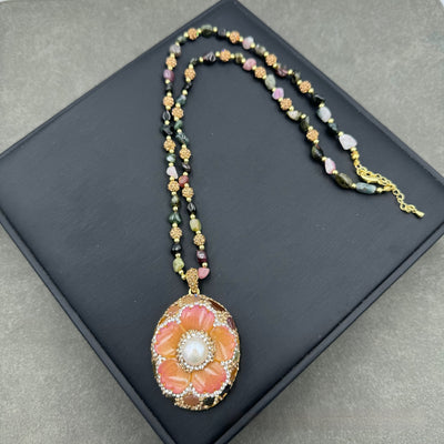 Gold-toned dangle earrings with oval drops, featuring a carved pink flower, clear rhinestones, and multi-colored tourmaline. - Image 2