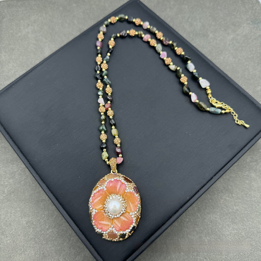 Gold-toned dangle earrings with oval drops, featuring a carved pink flower, clear rhinestones, and multi-colored tourmaline. - Image 2
