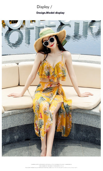 Pink tropical print three-piece women's swimwear set with ruffled bikini top, high-waisted bottoms, and matching sarong. - Image 14