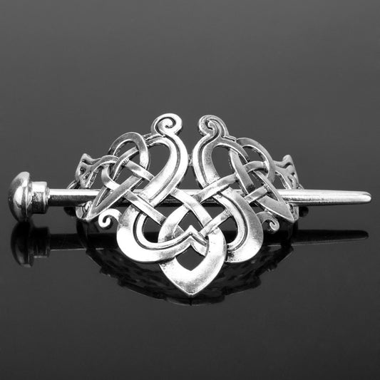 Silver metal hair clip with a retro dragon head and infinity knot design, secured by a plug-in hairpin.
