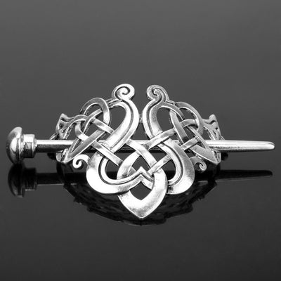 Silver metal hair clip with a retro dragon head and infinity knot design, secured by a plug-in hairpin.
