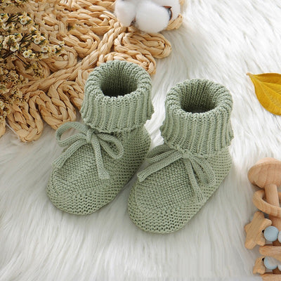 Pink knitted infant toddler shoes with cute bowknots and elastic bands, displayed on a soft white rug. - Image 9
