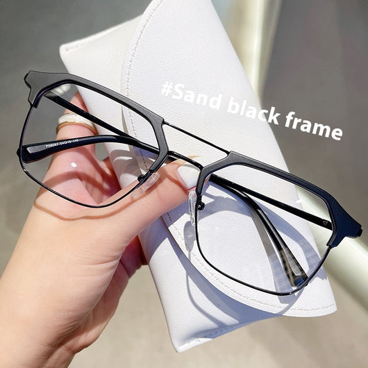 Anti-blue light glasses with a sand black and silver double beam frame, held against a white case. - Image 9