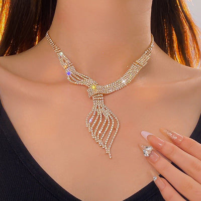 Gold-tone rhinestone necklace and matching dangle earrings set. The necklace features a multi-strand, leaf-like design. - Image 9