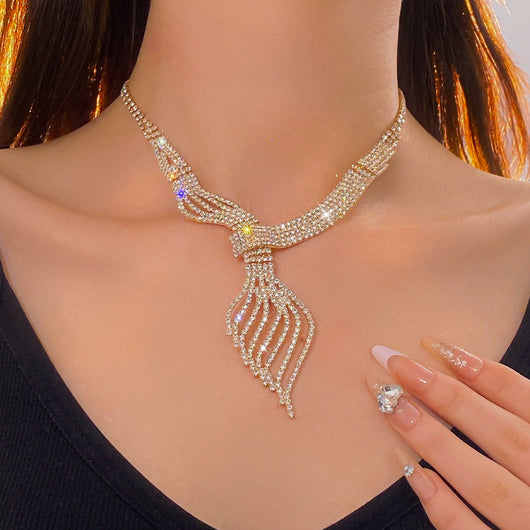Gold-tone rhinestone necklace and matching dangle earrings set. The necklace features a multi-strand, leaf-like design. - Image 9
