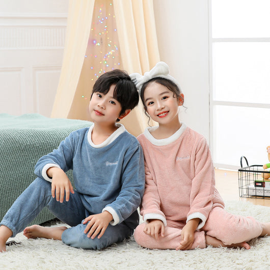Reddish-brown coral velvet children's loungewear set with a long-sleeved top and matching pants, featuring white trim.