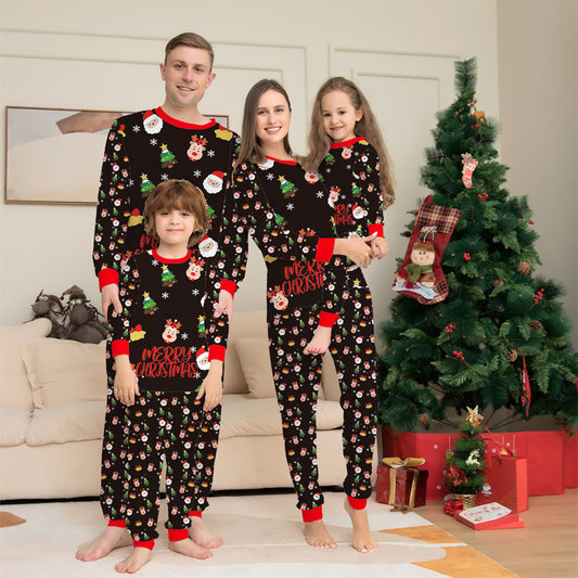 Man wearing a black long-sleeve Christmas pajama set with Santa, reindeer, and Christmas tree patterns.
