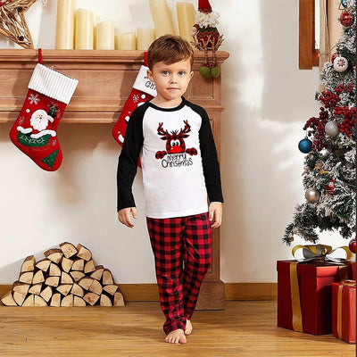 Family matching Christmas pajamas with a deer graphic and "Merry Christmas" text on white and black tops, paired with red and black buffalo plaid pants. - Image 8