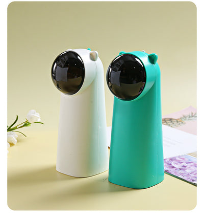 White automatic laser cat toy with a black dome projector and small cat ear details on top, featuring a green button. - Image 6