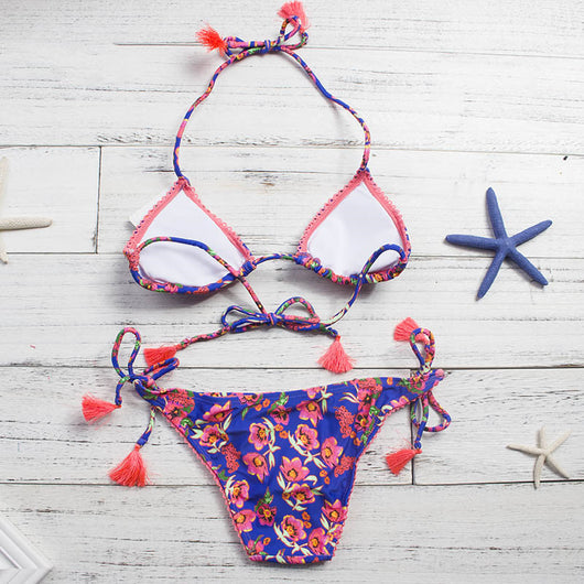 Women's blue floral print bikini with pink flowers, green leaves, coral trim, and orange tassels on ties. - Image 7