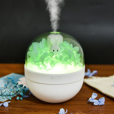 White spherical aroma diffuser with clear dome, featuring preserved blue roses, blue hydrangea, and a white rabbit figurine. - Image 10