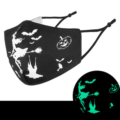 Black cloth face mask with white Halloween witch, bats, and jack-o'-lantern pattern, shown glowing green in the dark. - Image 3