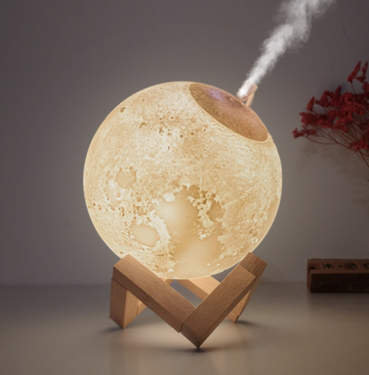 Moon-shaped humidifier and night light with a white deer stand, emitting mist, on a wooden table with books. - Image 9