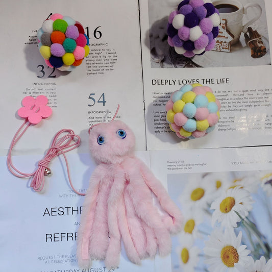 Purple plush cat teaser toy with googly eyes, elastic strings, and a pink flower attachment, resembling an octopus. - Image 2