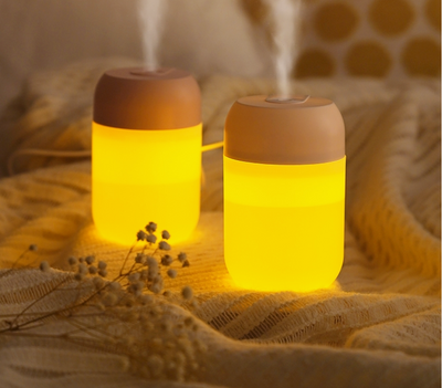 White cylindrical mini humidifier with a soft yellow glow, suitable for air moisturizing and aromatherapy, USB powered. - Image 9