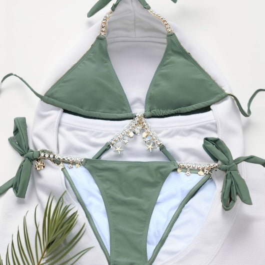 Olive green split bikini with gold chain and charm embellishments, worn with a sheer white cover-up on a beach. - Image 4