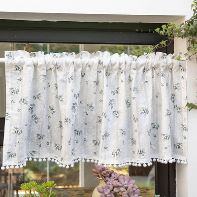White semi-sheer curtain with green and grey floral pattern and cream tassel trim, hanging in a window. - Image 3