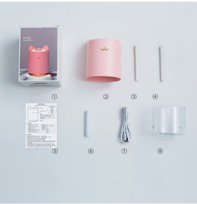 White mini USB humidifier with cat ears and a gold cat nose/mouth emblem, featuring a clear water tank base. - Image 7