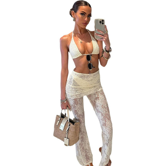 Woman wearing a white lace two-piece swimsuit set with a halter bikini top and sheer high-waisted flare pants. - Image 5