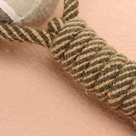 Braided rope dog chew toy with two tennis balls featuring paw prints, shown with a dog holding a similar toy. - Image 6