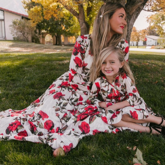 Mother and daughter in matching white dresses with red floral print, V-neck, long sleeves, and tie-waist. - Image 2