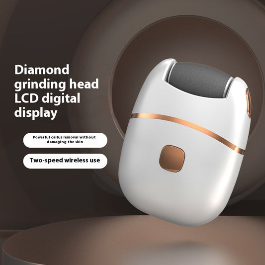 White and gold electric foot callus remover with a roller head, a replacement roller, cleaning brush, and USB cable.