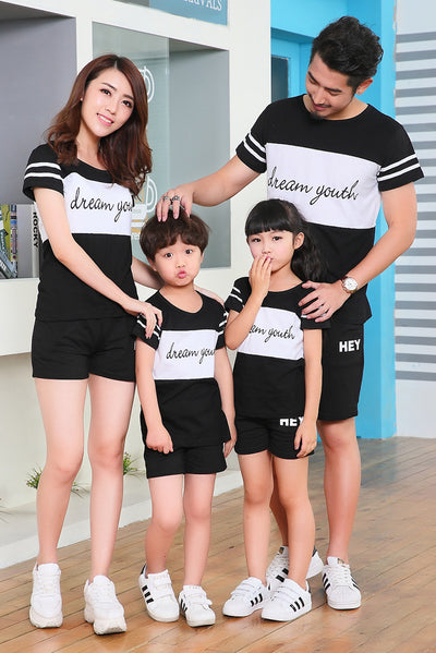 Young girl in a white short-sleeve t-shirt with a black stripe and black shorts, wearing a black cap. - Image 15