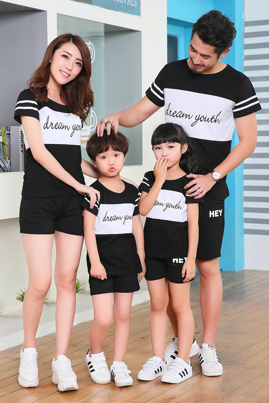 Young girl in a white short-sleeve t-shirt with a black stripe and black shorts, wearing a black cap. - Image 15