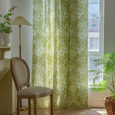 Green curtain with white leafy botanical pattern and cream tassels, hanging in a window with natural light. - Image 8