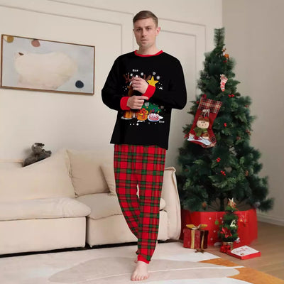 Two children in black and red plaid Christmas pajamas with a reindeer and Christmas tree graphic, standing by a Christmas tree. - Image 3