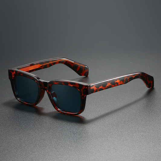 Black square-frame sunglasses with bright orange polarized lenses, designed for outdoor driving and anti-glare.