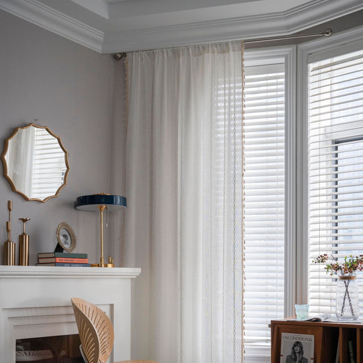 Black polyester curtain with white jacquard multi-line pattern and black tassels, draped over a white chair. - Image 16