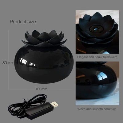 Black spherical aromatherapy humidifier with a lotus flower top, emitting mist, sitting on a gold decorative doily. - Image 9