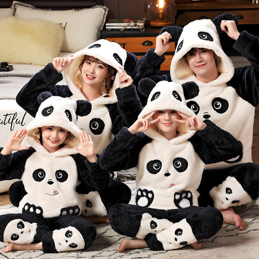 Family wearing matching black and white panda plush housewear suits with hoods and checkered pants, posing indoors. - Image 7