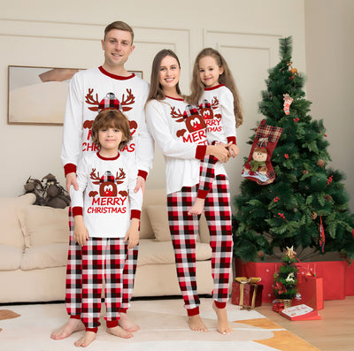 Young girl in a white long-sleeve Christmas pajama top with a reindeer graphic and red plaid pajama pants. - Image 10